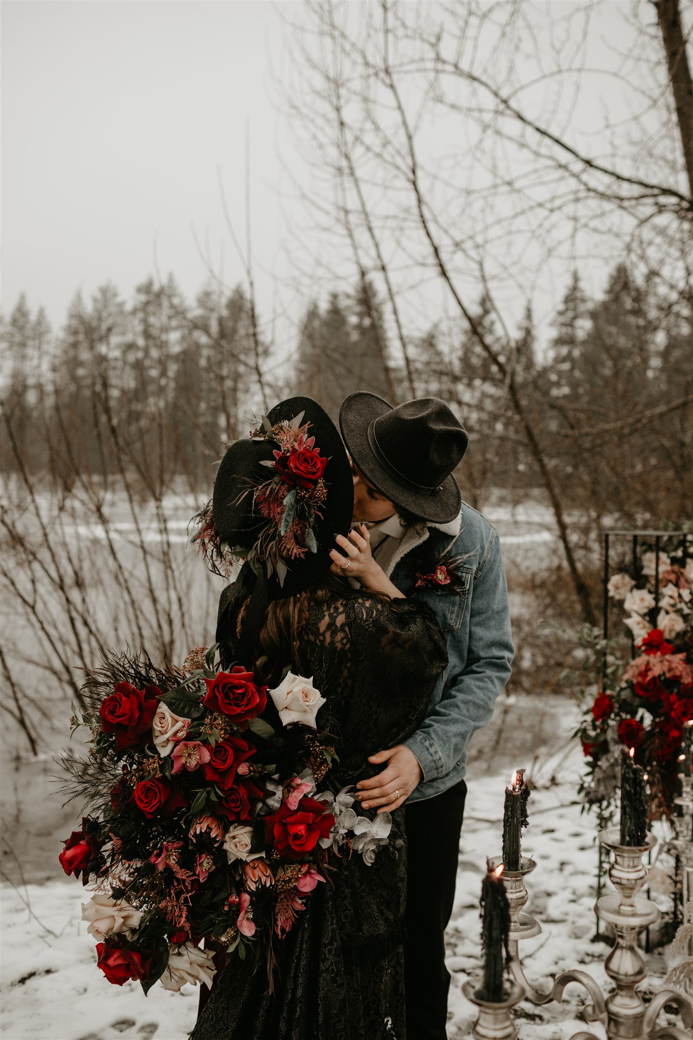 Boho bride in a black wedding dress and black wedding hat with boho groom