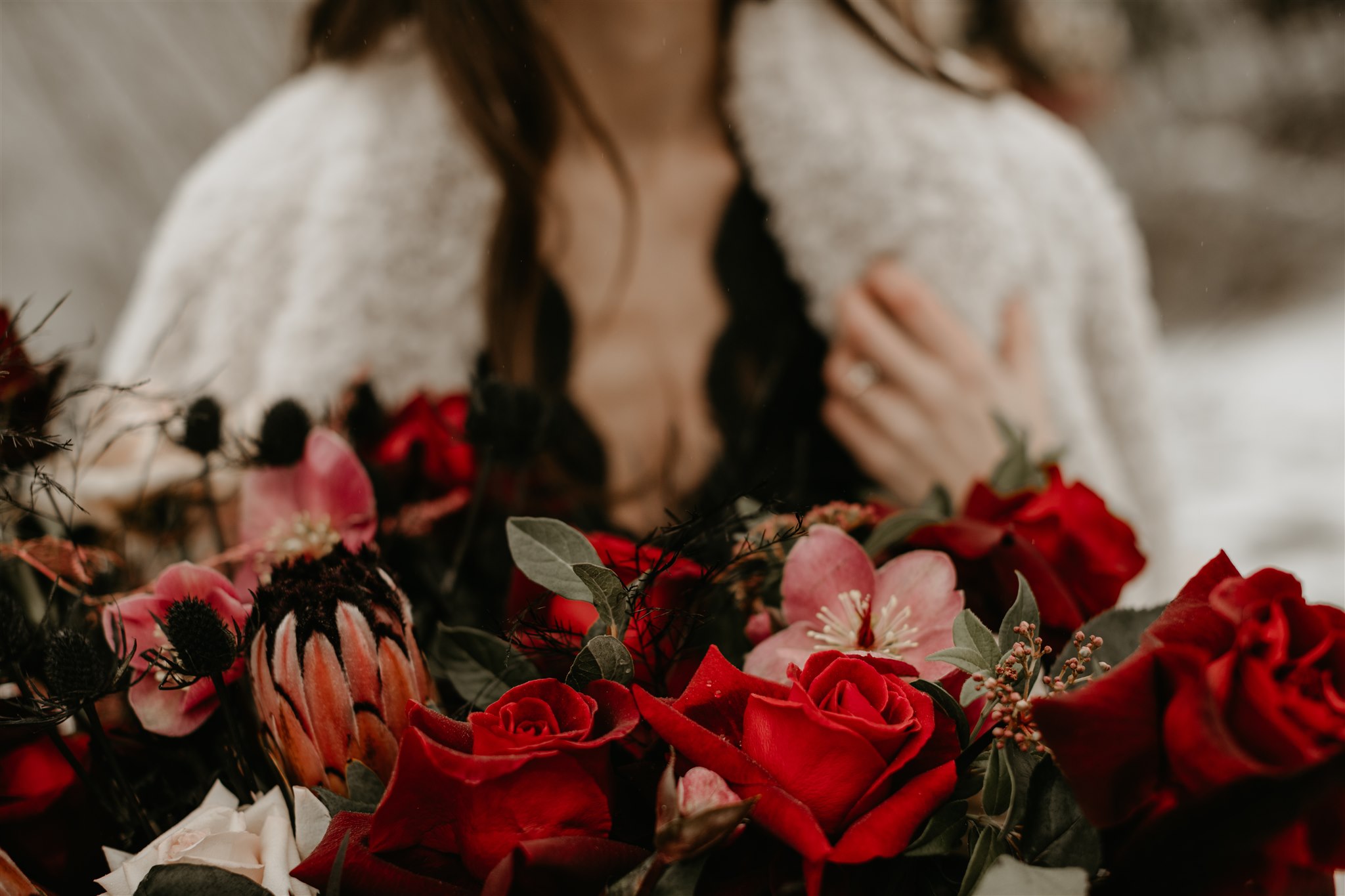 Winter Bride wearing furry coat holding red bouquet