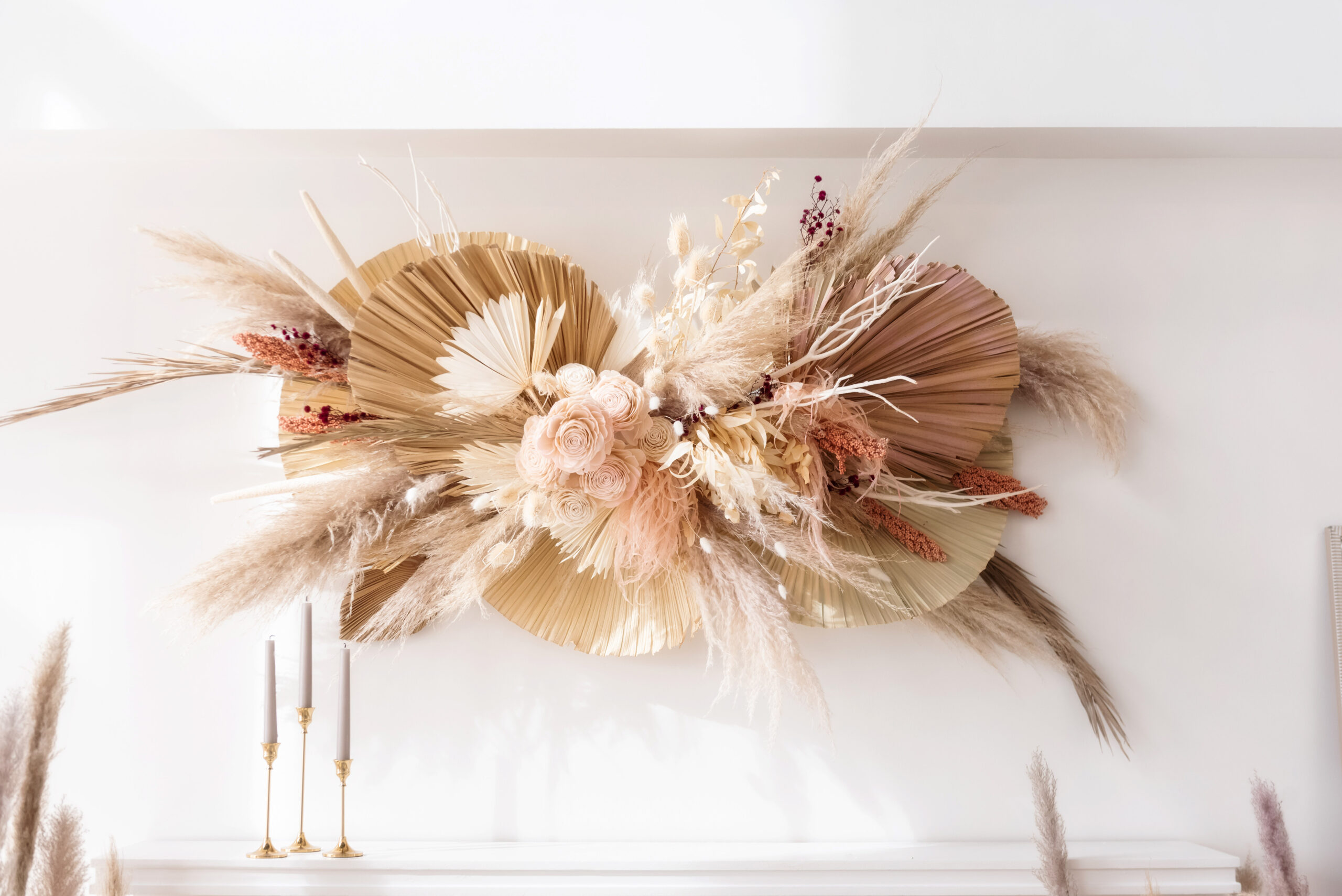 Natural grasses, boho decor and linen colored flowers above white mantle