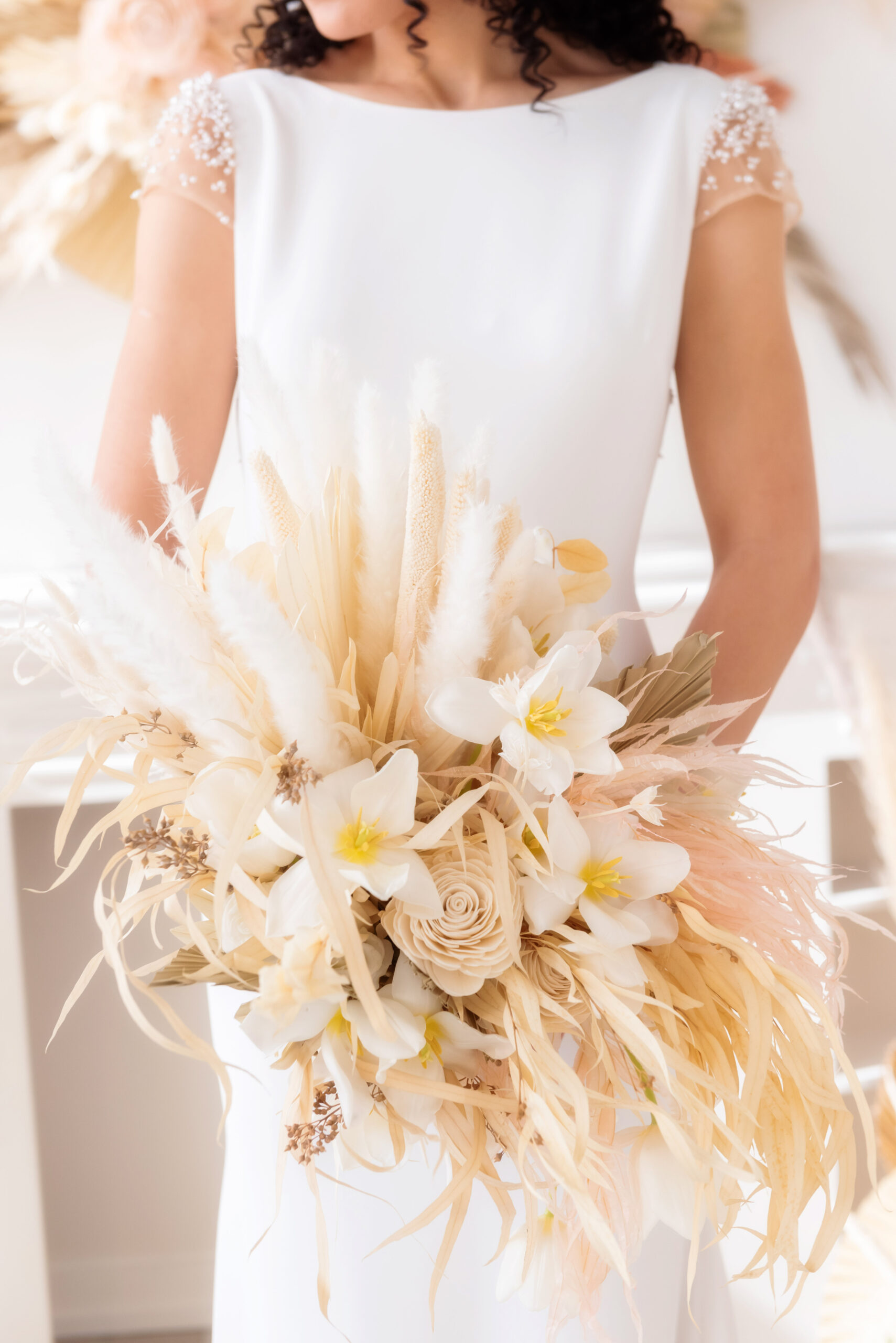 Wedding bouquet with natural grasses, cream and ivory coloured flowers
