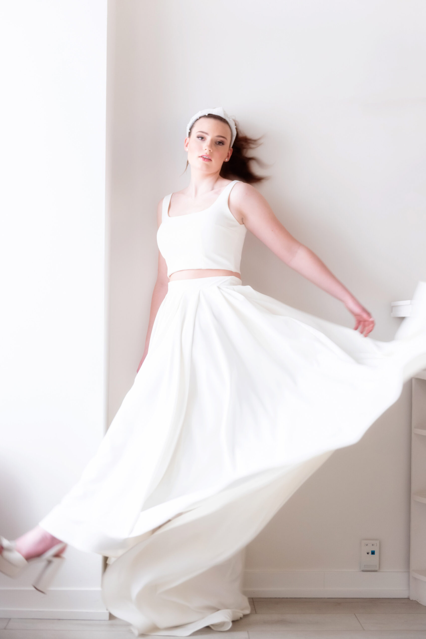 Bride in flirty, youthful two piece wedding gown, twirling skirt