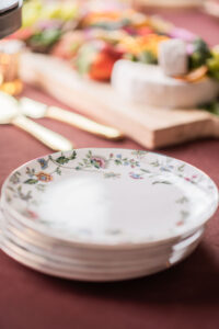 Vintage floral tea plates on a maroon tablecloth