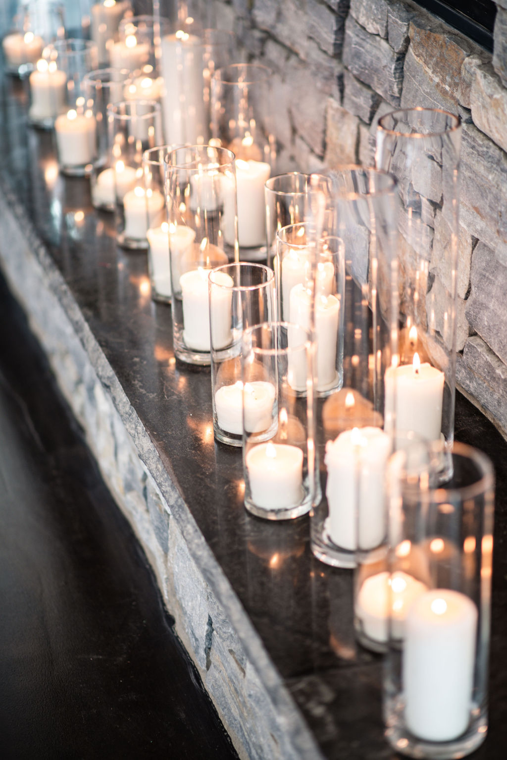 Long mantle of white candles in candle vases