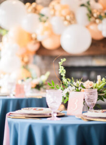 Wedding tablesetting with blue tablecloth and peach and vintage details