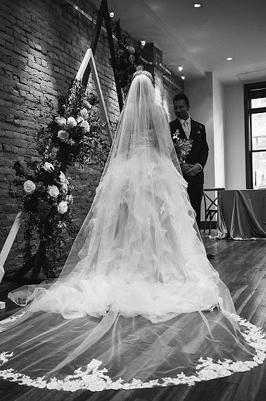 Black and white photo of bride's delicate embroidered cathedral veil