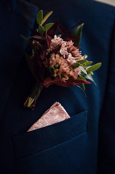 Menswear navy groom suit details with pink pocket square and boutinueere