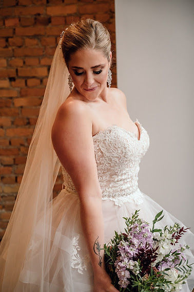 Bride looking over her shoulder holding bouquet