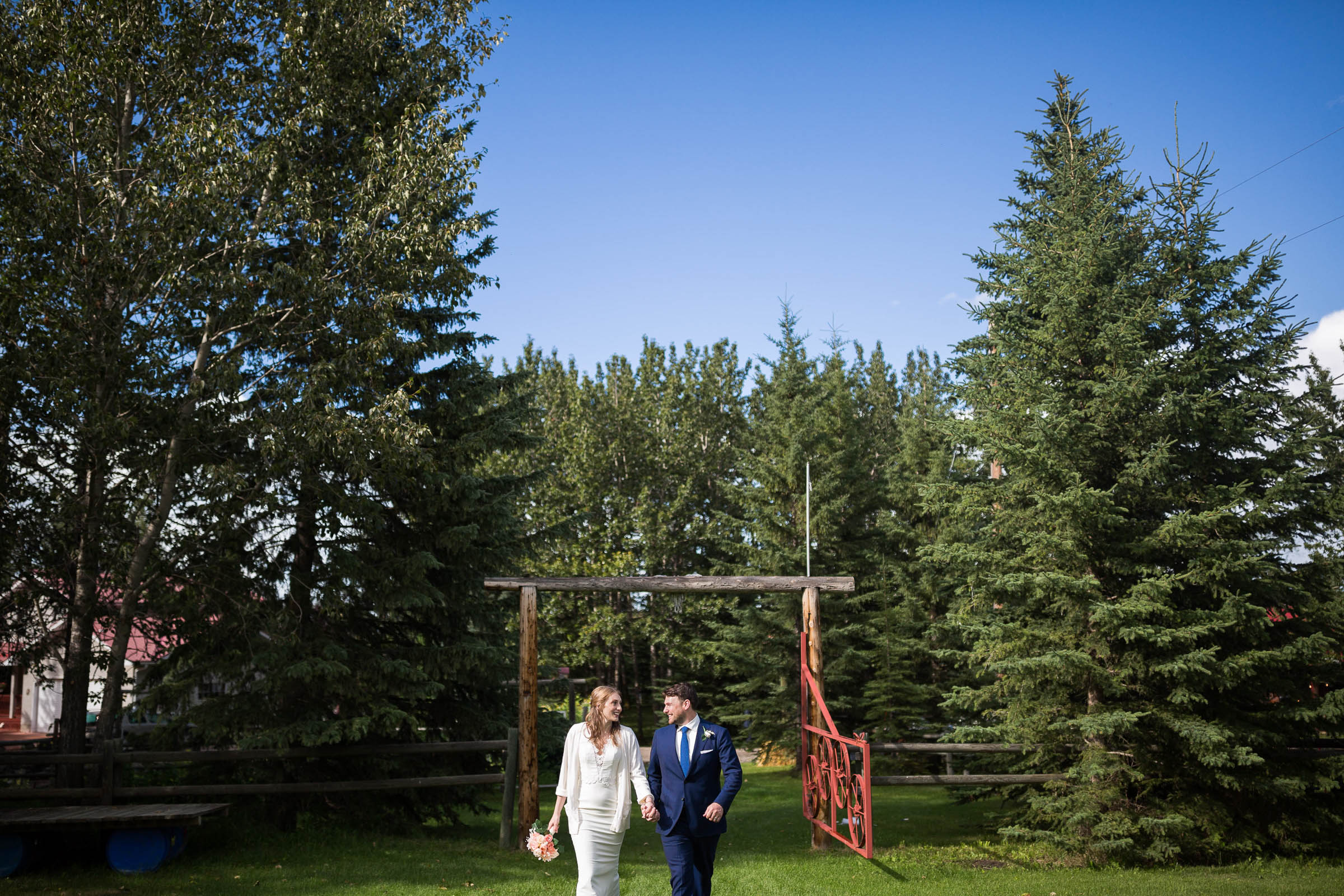 Bride and groom holding hands celebrating new marriage