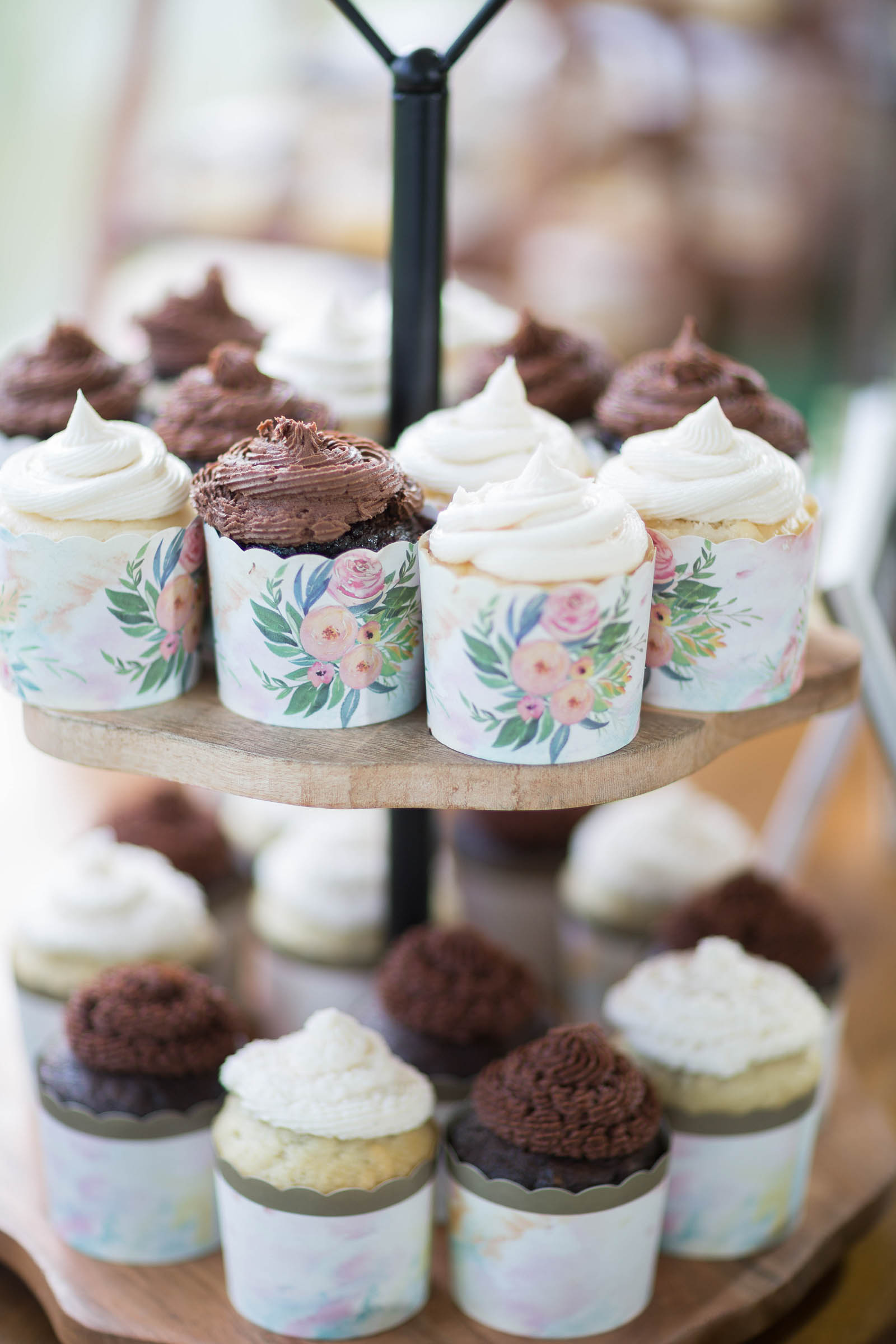 Chocolate and vanilla cupcakes in sweet paper cups with floral design