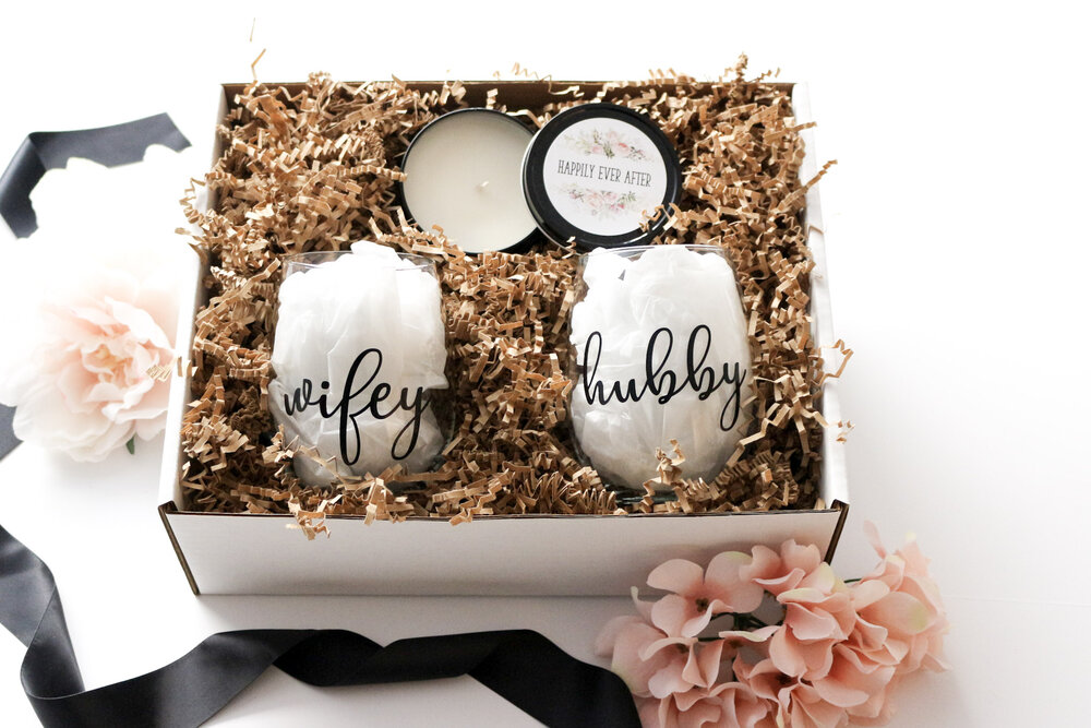 Couple box with a hubby and wifey stemless wine glass set in a personalized box with black bow.