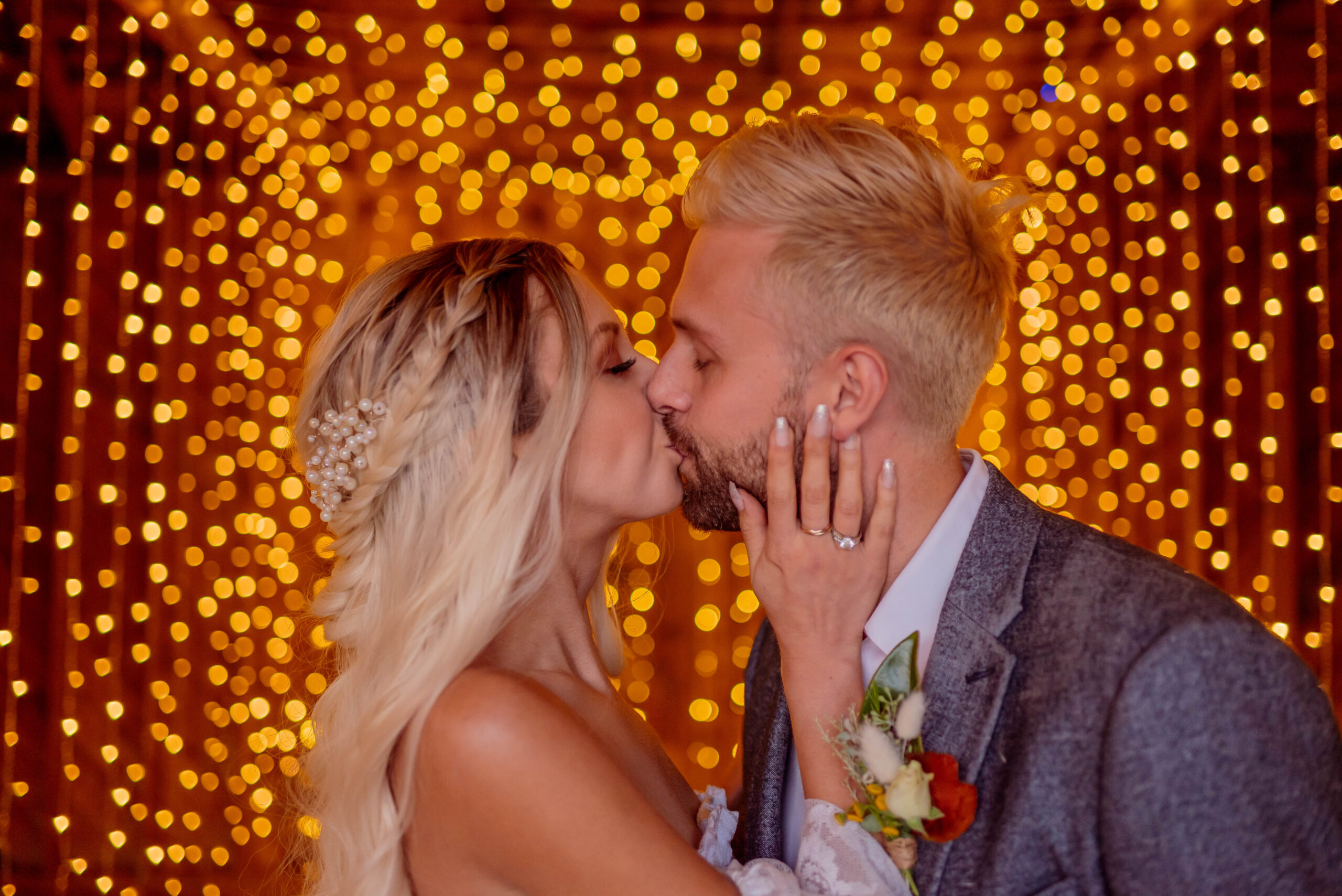 Bridge and Groom kissing with twinkle lights